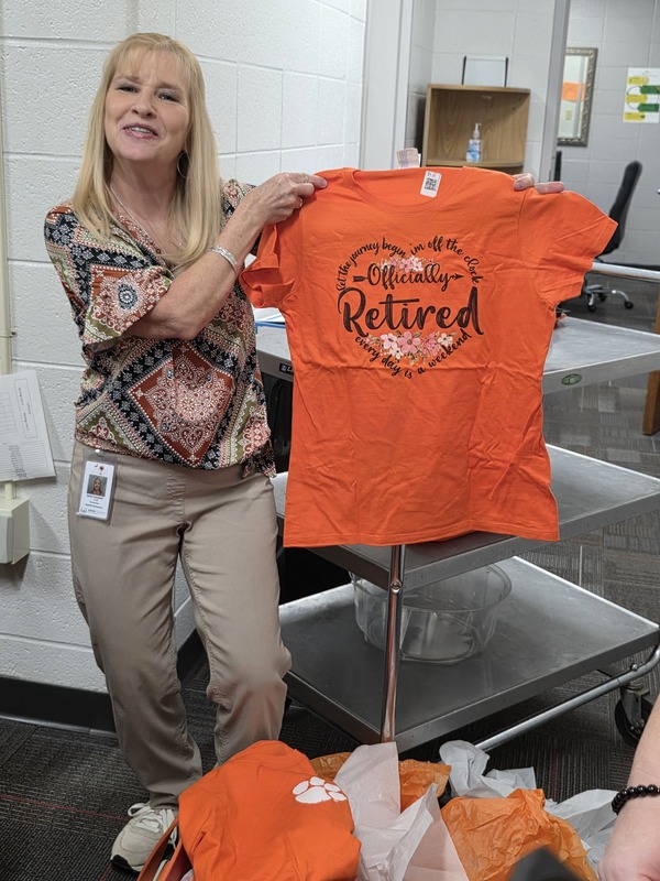 Woman holding shirt.
