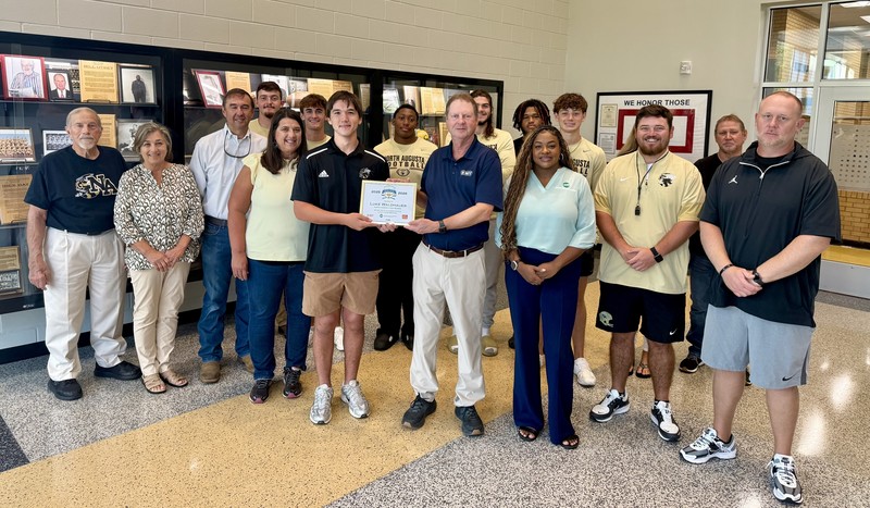 LUKE WALDHAUER OF NORTH AUGUSTA HIGH HONORED AS SCHOLAR ATHLETE POSING WITH FAMILY, COACHES, AND TEAMMATES.