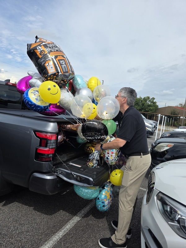 Man putting ballons in truck.