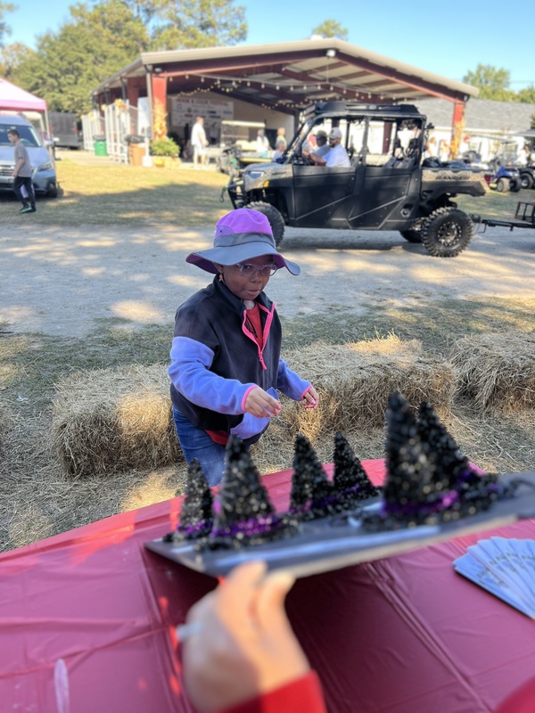 Student at Hook n Cook festival tossing rings.
