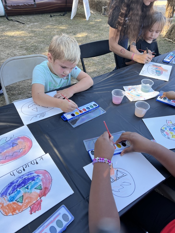 Student at Hook n Cook festival painting.