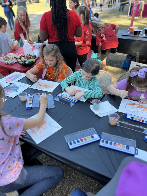 Students painting at Hook n Cook festival.