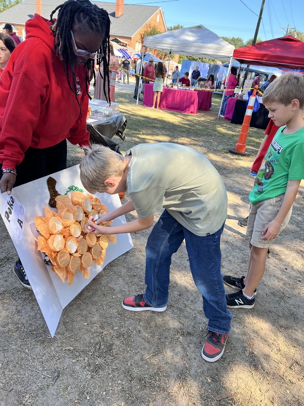Student playing game at Hook n Cook festival.