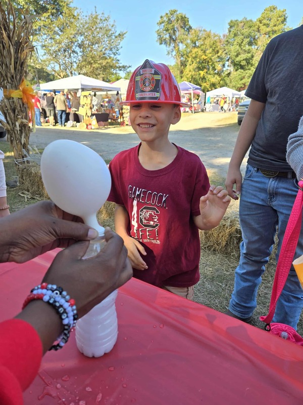 Student doing activity at Hook n Cook festival.