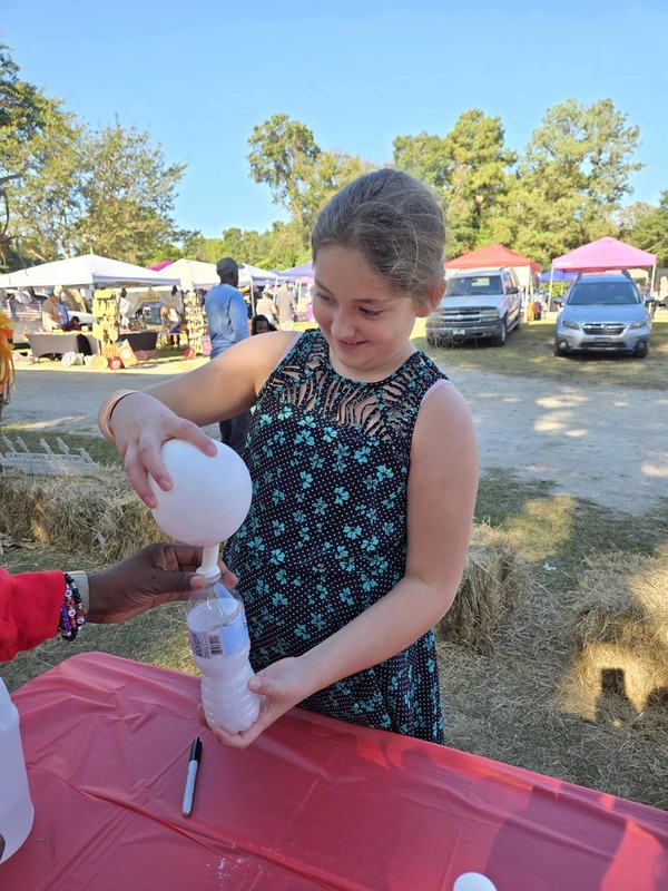 Student doing activity at Hook n Cook festival.