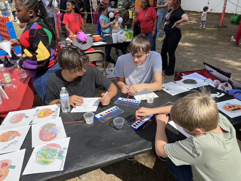 Students painting at Hook n Cook festival.