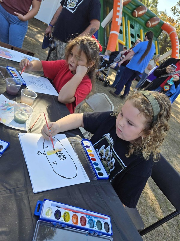 Students painting at Hook n Cook festival.