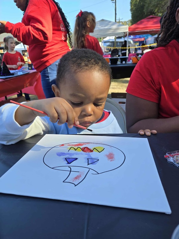 Student painting at Hook n Cook festival.
