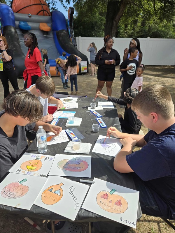 Students painting at Hook n Cook festival.