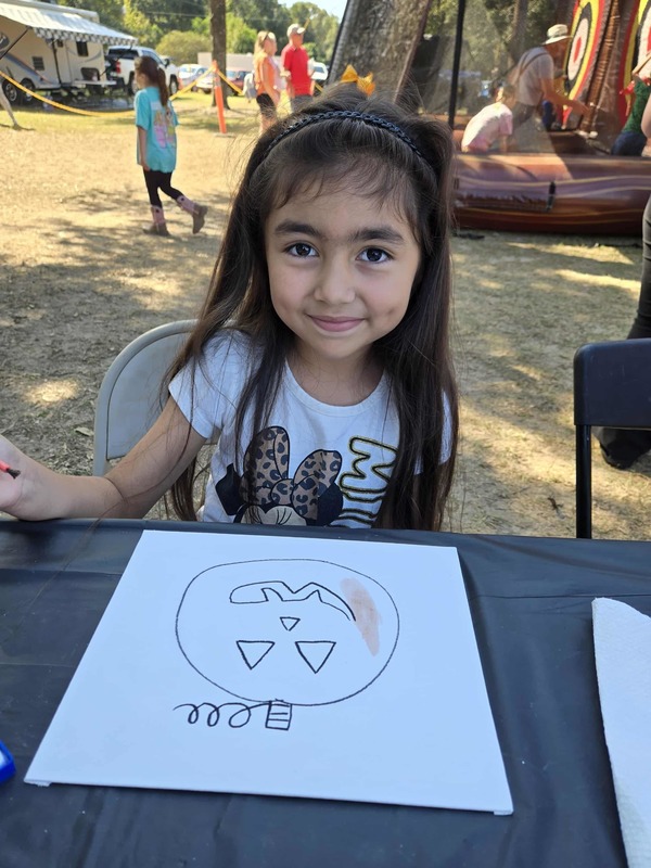 Student painting at Hook n Cook festival.