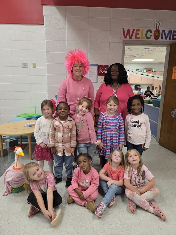 Group of students and staff wearing pink.