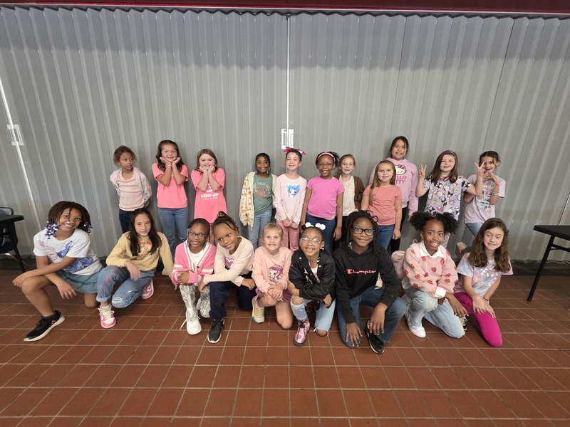 Group of students and staff wearing pink.