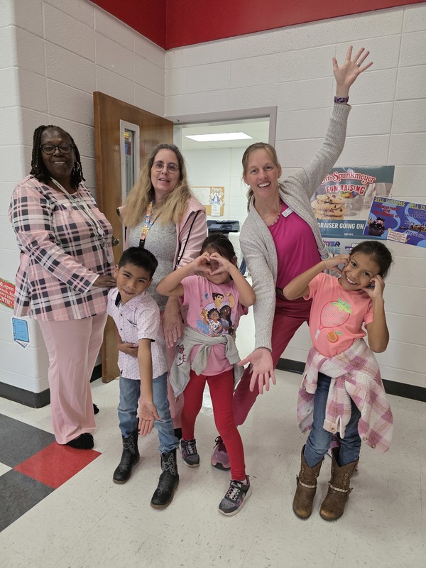 Group of students and staff wearing pink.