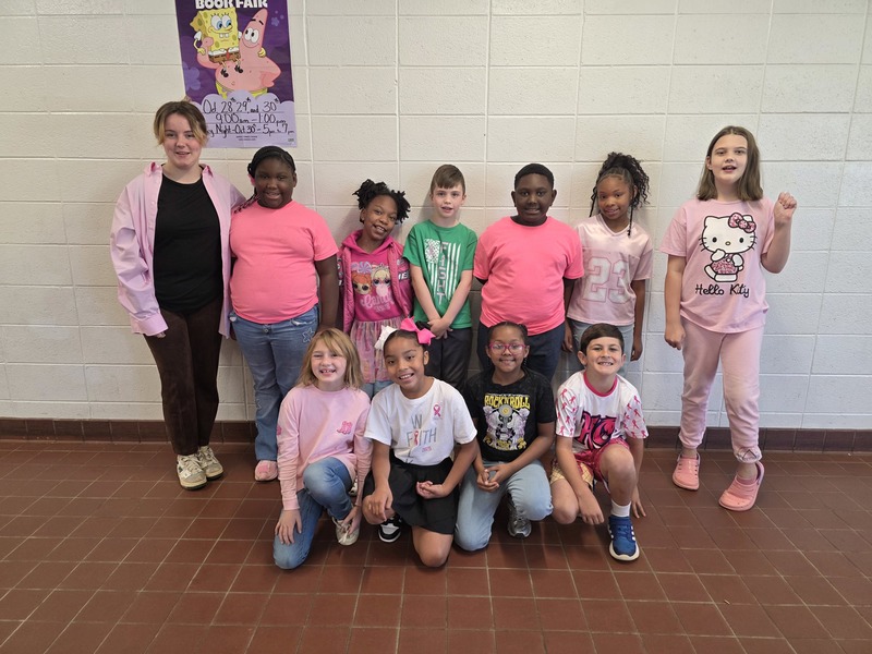 Group of students and staff wearing pink.