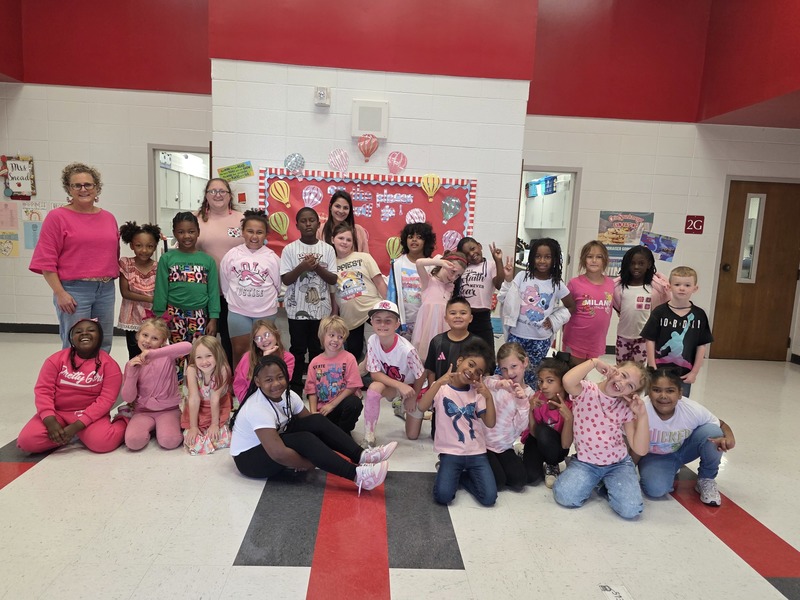 Group of students and staff wearing pink.