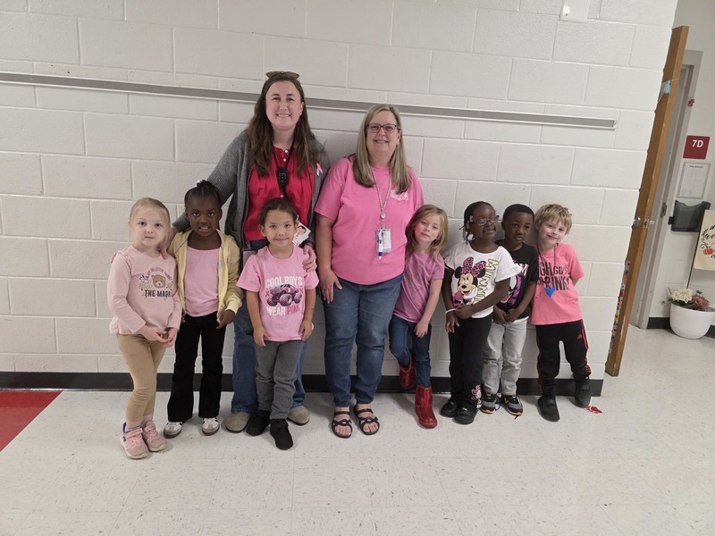 Group of students and staff wearing pink.