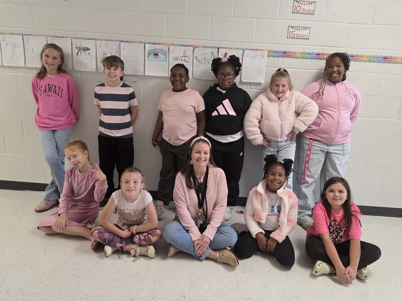 Group of students and staff wearing pink.
