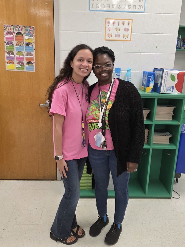 Two teachers wearing pink.