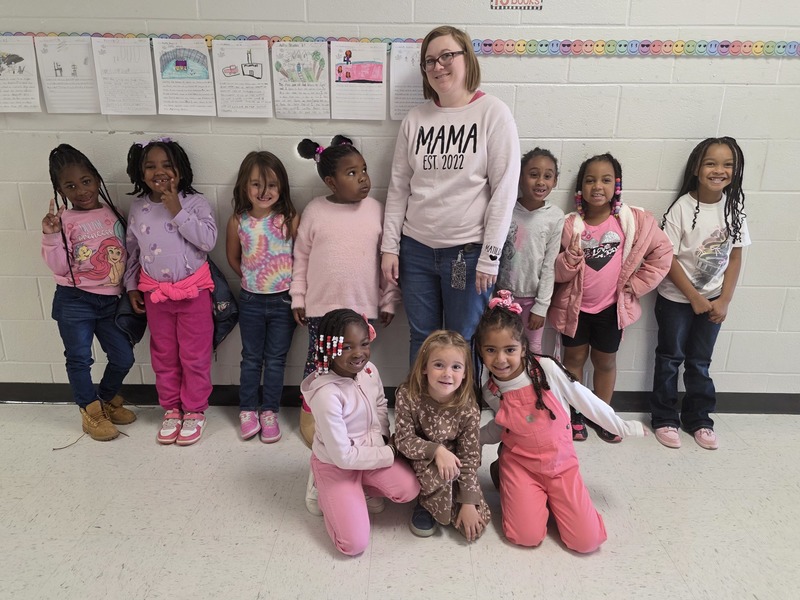 Group of students and staff wearing pink.