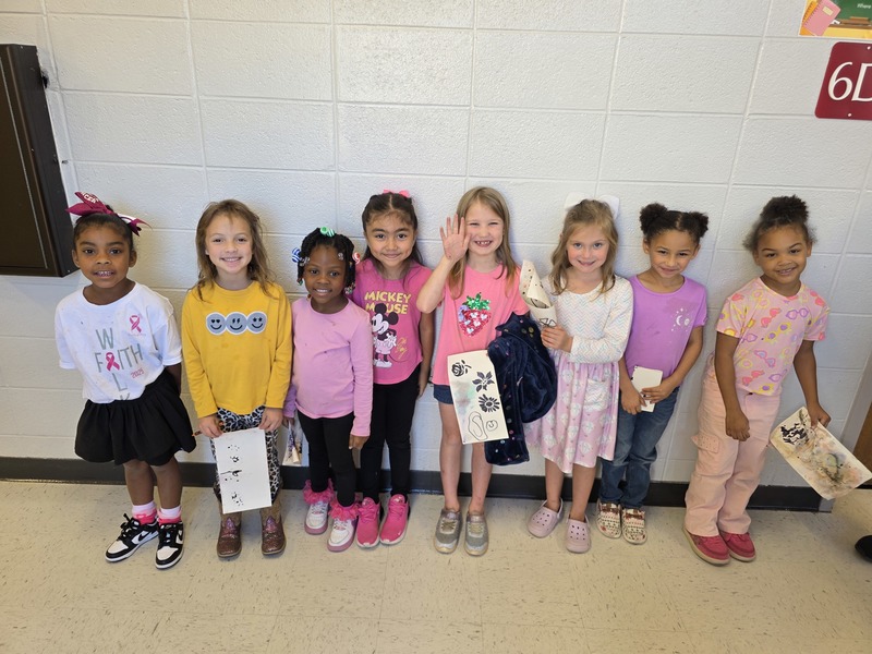 Group of students and staff wearing pink.