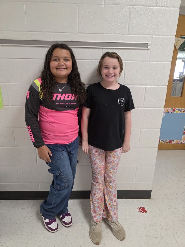 Two students wearing pink.