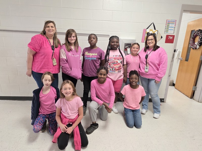 Group of students and staff wearing pink.