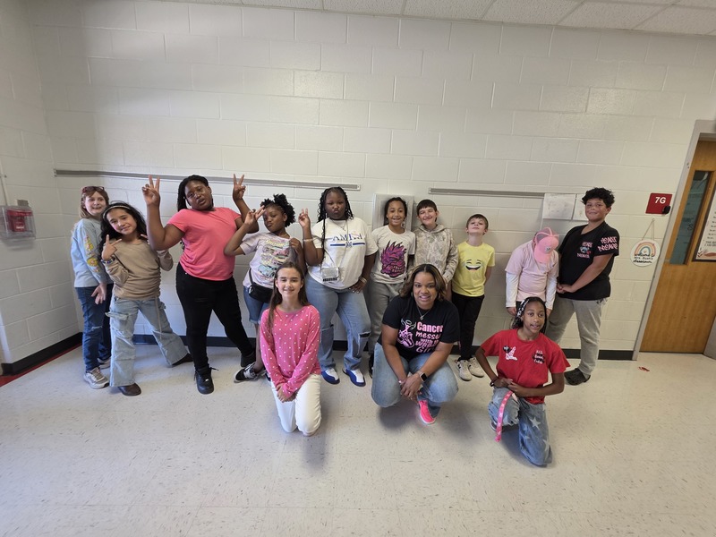 Group of students and staff wearing pink.