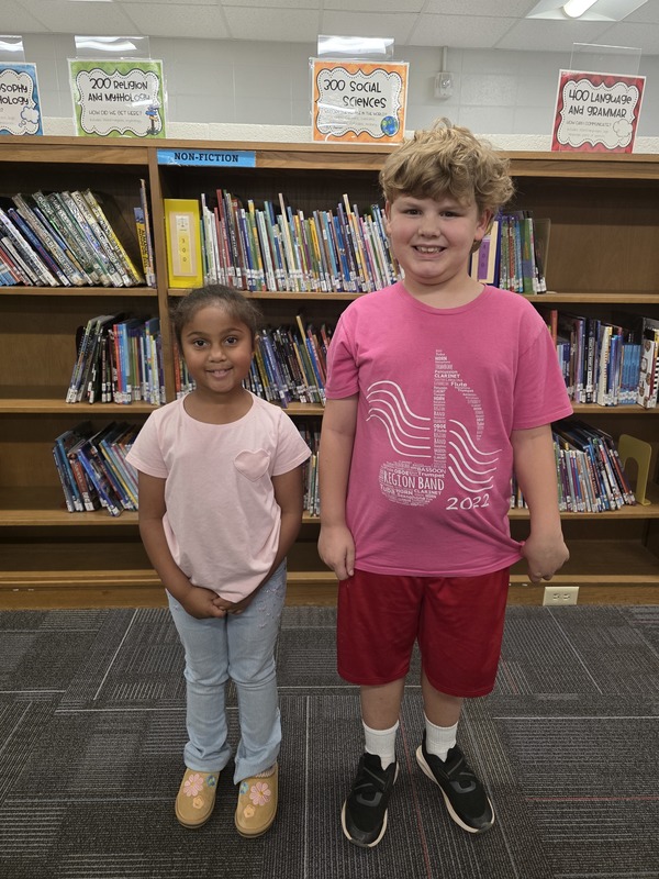 Two students wearing pink.