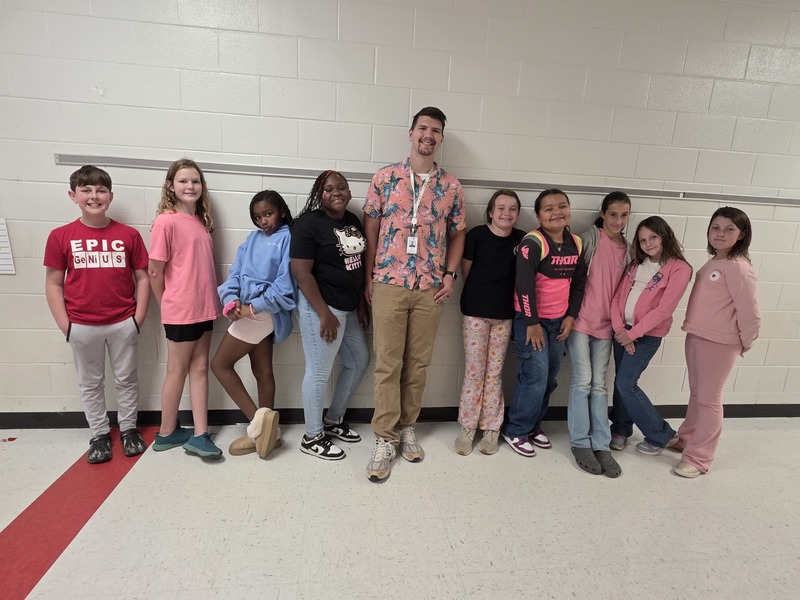 Group of students and staff wearing pink.