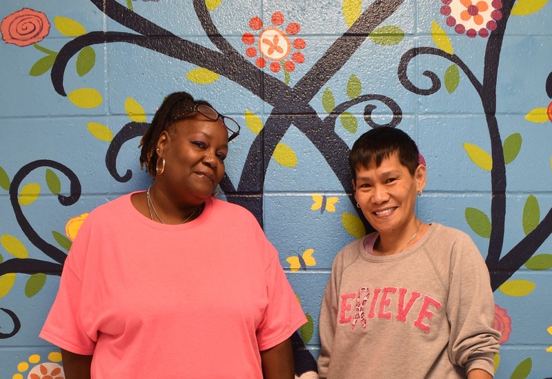 Two staff members wearing pink.