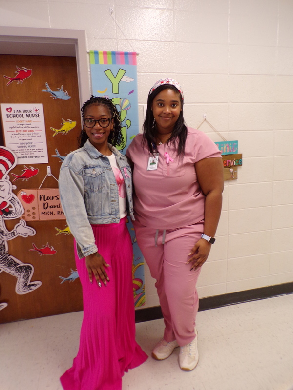 Two staff wearing pink.