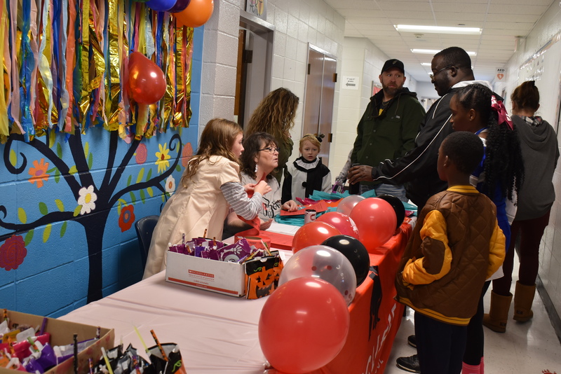 Welcome table staff handing out bags.