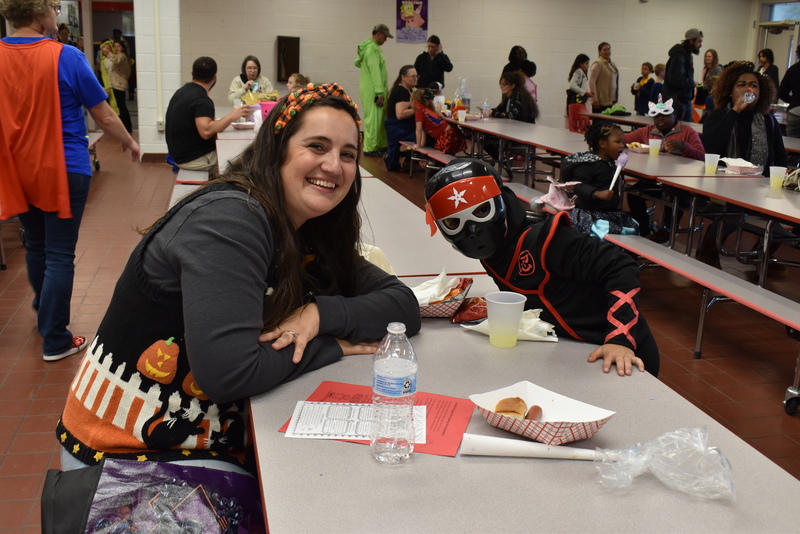 Families at food table.