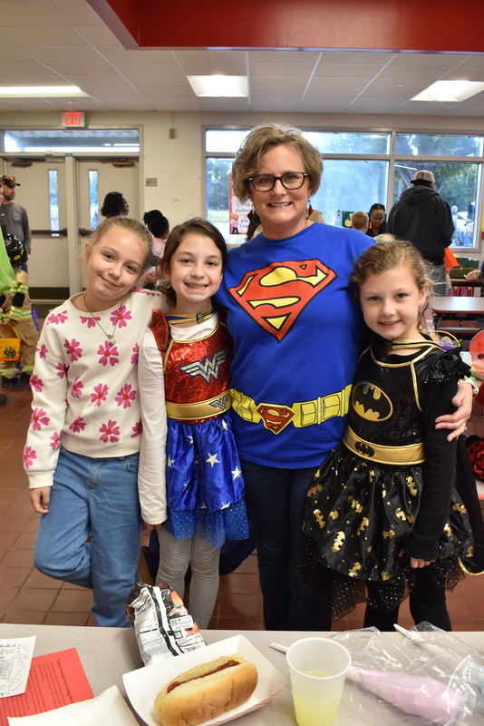 Students and staff in food area.