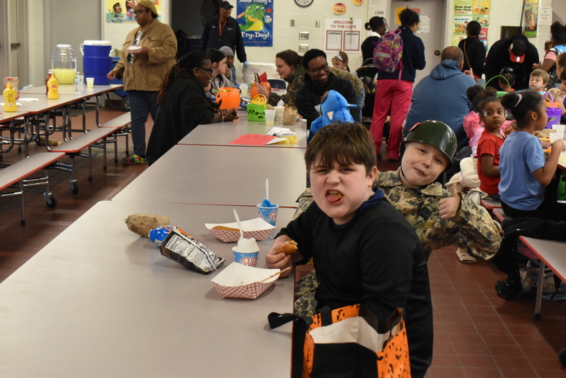 Families at food table.