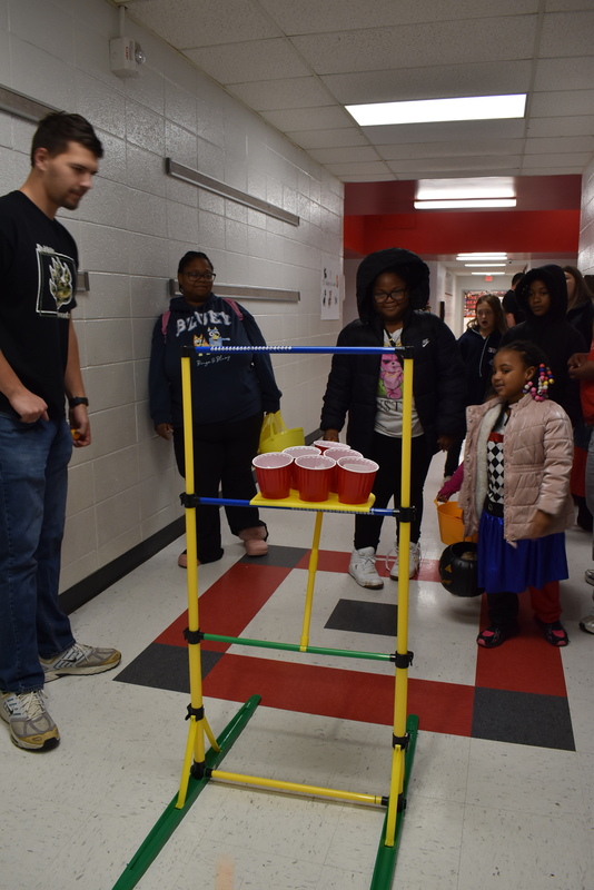 Students playing carnival game.