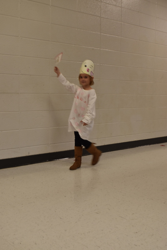 Students wearing costumes to represent letters of the alphabet in a parade.