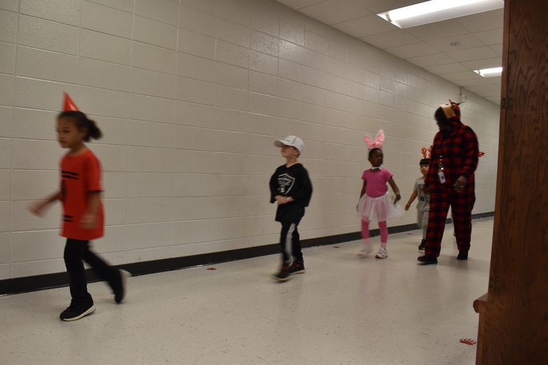 Students wearing costumes to represent letters of the alphabet in a parade.
