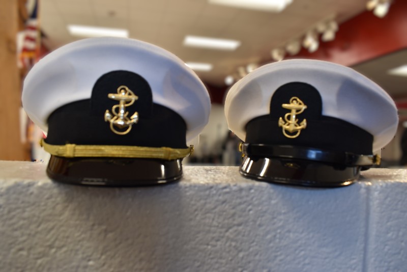 NJROTC hats on wall.