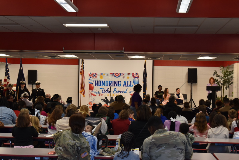 Principal addressing crowd.