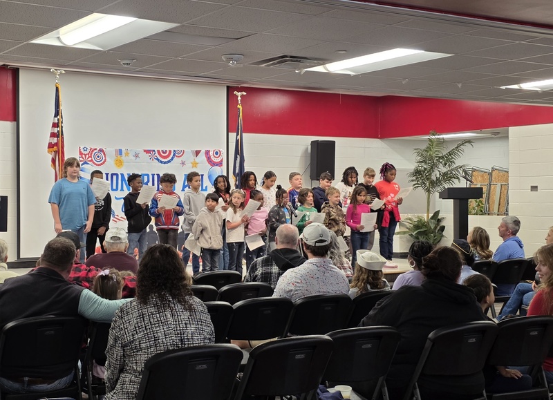 Class singing for crowd.