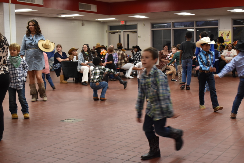 Families at rodeo dance.