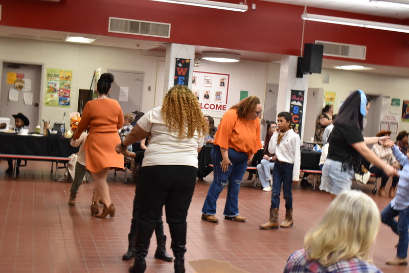 Families at rodeo dance.