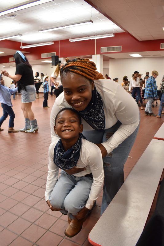 Families at rodeo dance.