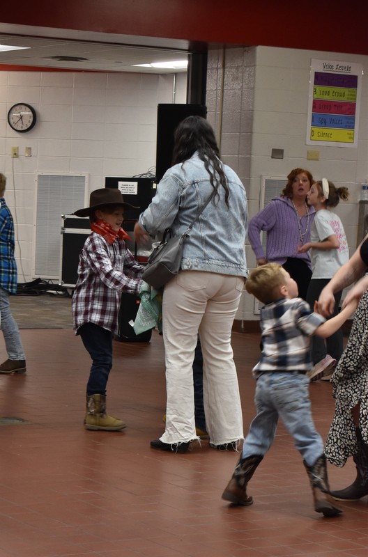 Families at rodeo dance.