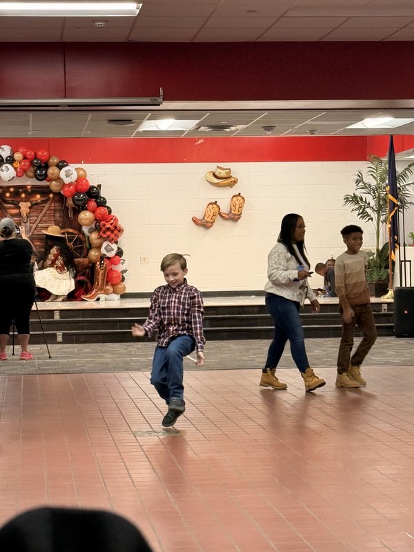 Families dancing at rodeo.