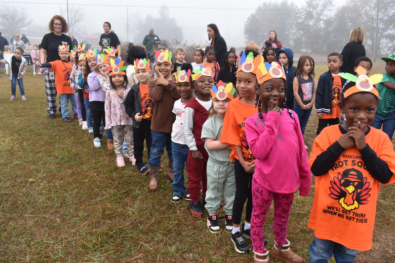 Students with turkey hats in line.