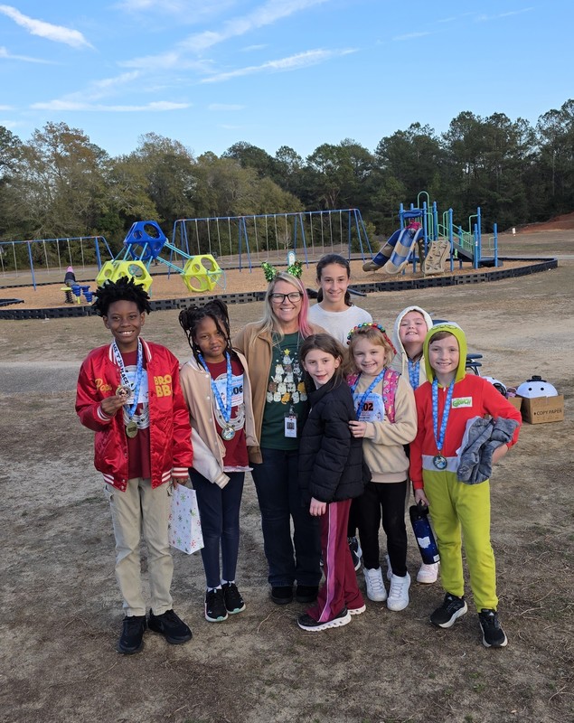 Runners with medals at end of race.