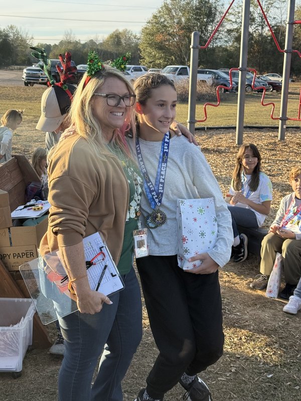 Runners with medals at end of race.