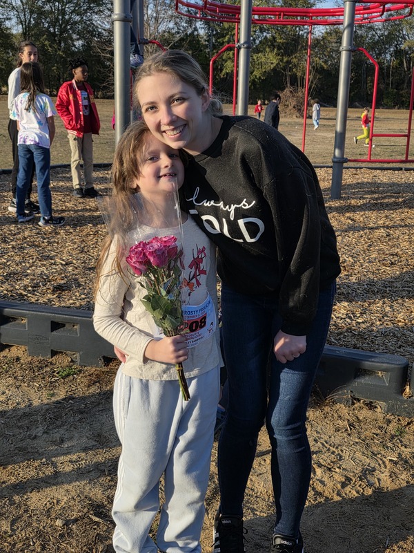 RUnner with family member and flowers.